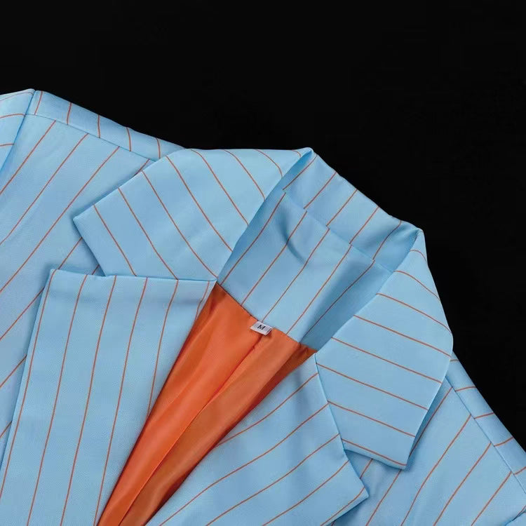 Close-up of Orchid Moda blue blazer skirt set with thin stripes and orange inner lining