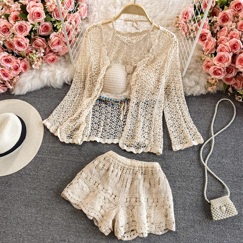 Orchid Moda beige crochet beachwear set with long-sleeve top and shorts styled with a sun hat and small purse