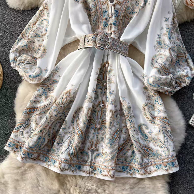 Orchid Moda floral paisley mini dress with puff sleeves and a matching belt in white blue and tan tones