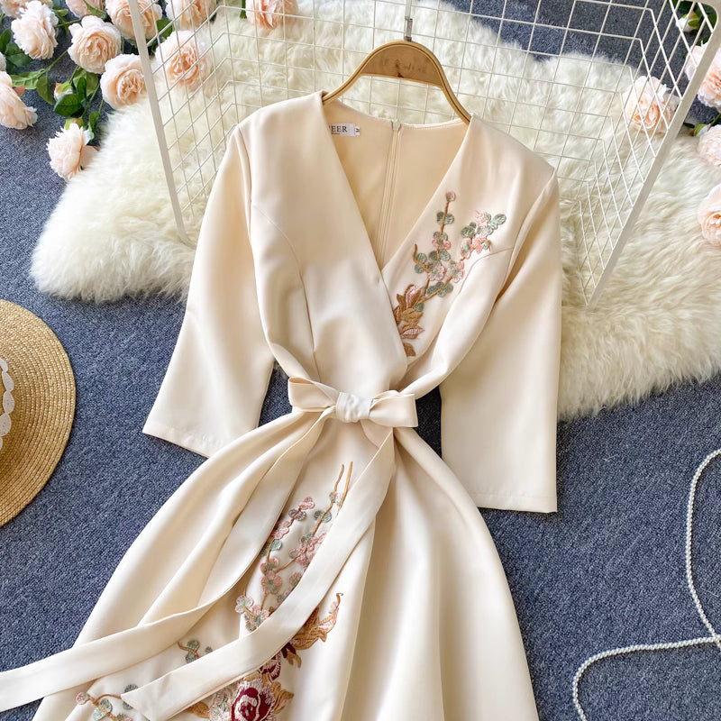 Orchid Moda almondine midi dress in cream with floral embroidery and a waist tie belt