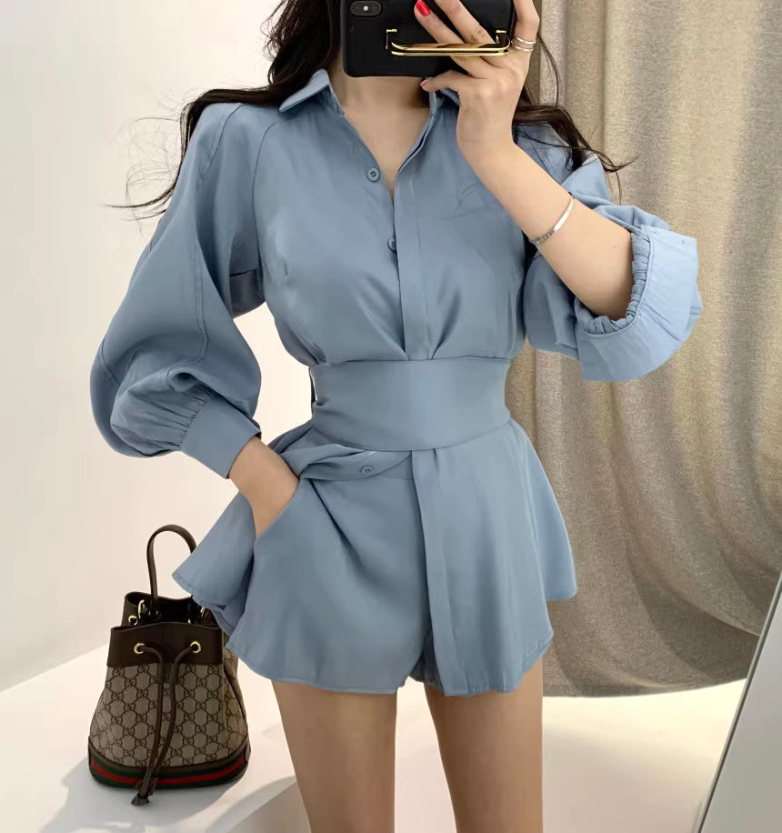 Woman wearing a blue retro co-ord set with puffed sleeves and high-waisted shorts by Orchid Moda