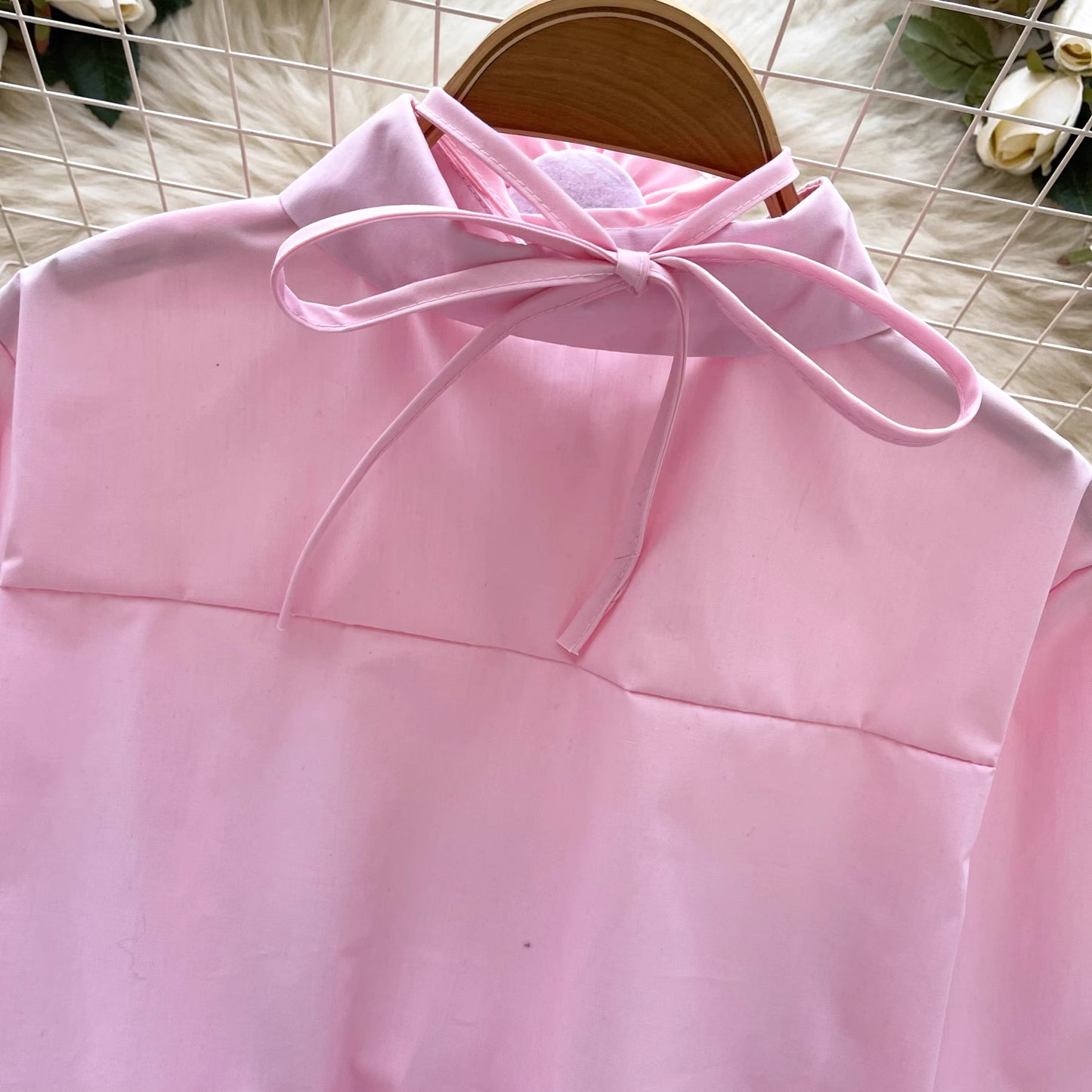 Orchid Moda ruffle rose pink shirt with back tie detail and soft fabric on wooden hanger
