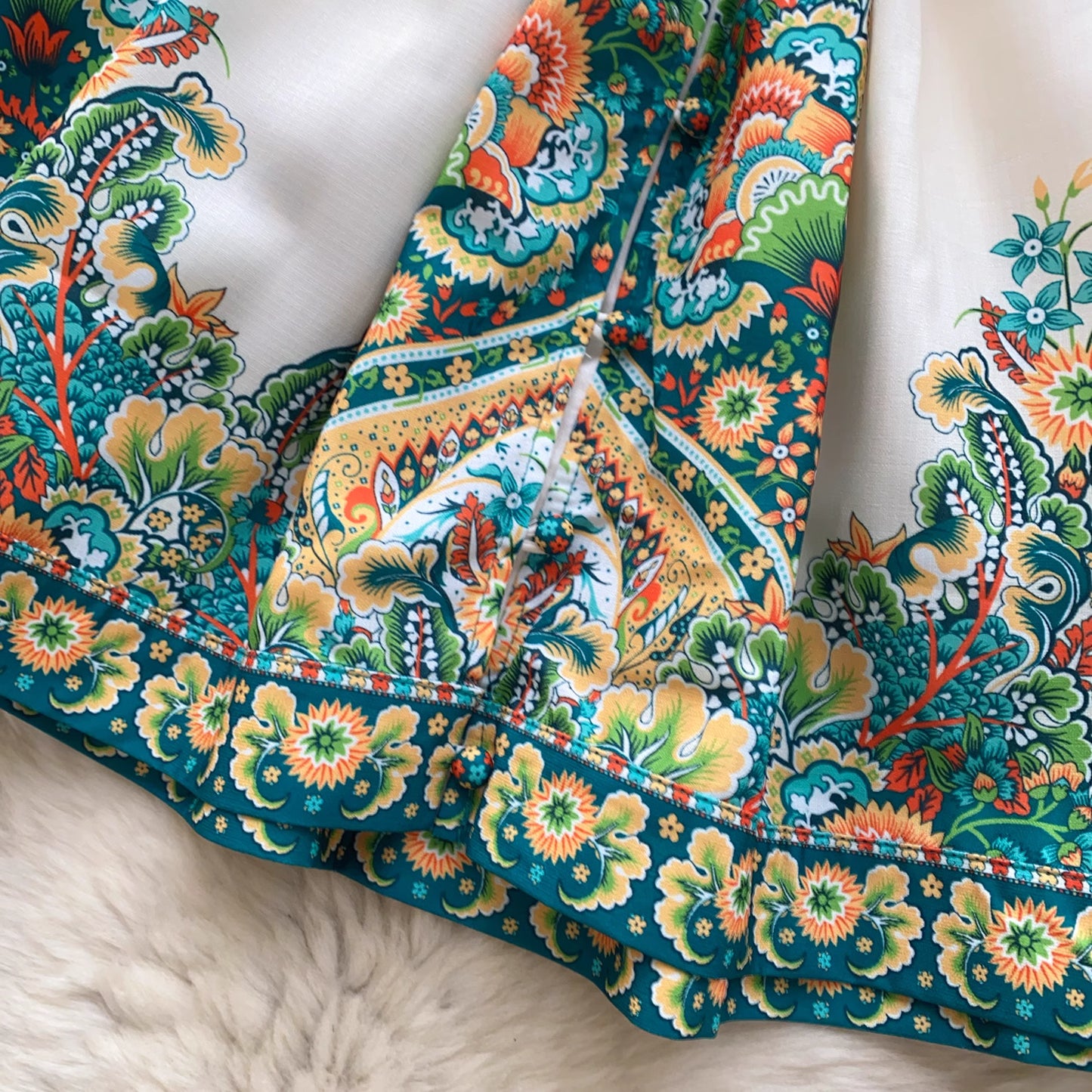 Close-up of colorful floral fabric pattern on trendy weekender dress for women by Orchid Moda