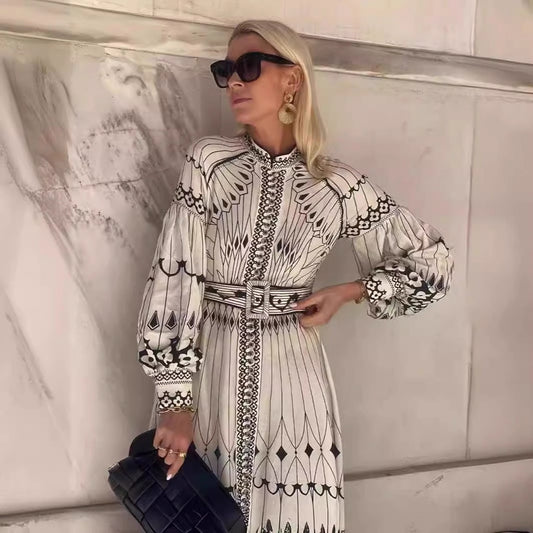 Orchid Moda bohemian midi dress with long puff sleeves and intricate black and white patterns