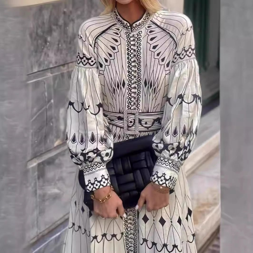 Orchid Moda bohemian midi dress in white with black geometric patterns and puffed long sleeves