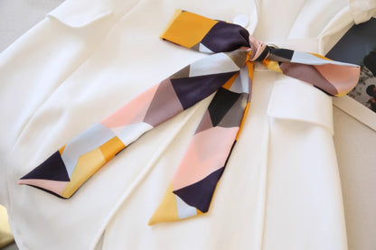 Orchid Moda chic cold shoulder blazer dress in white with colorful patterned necktie detail