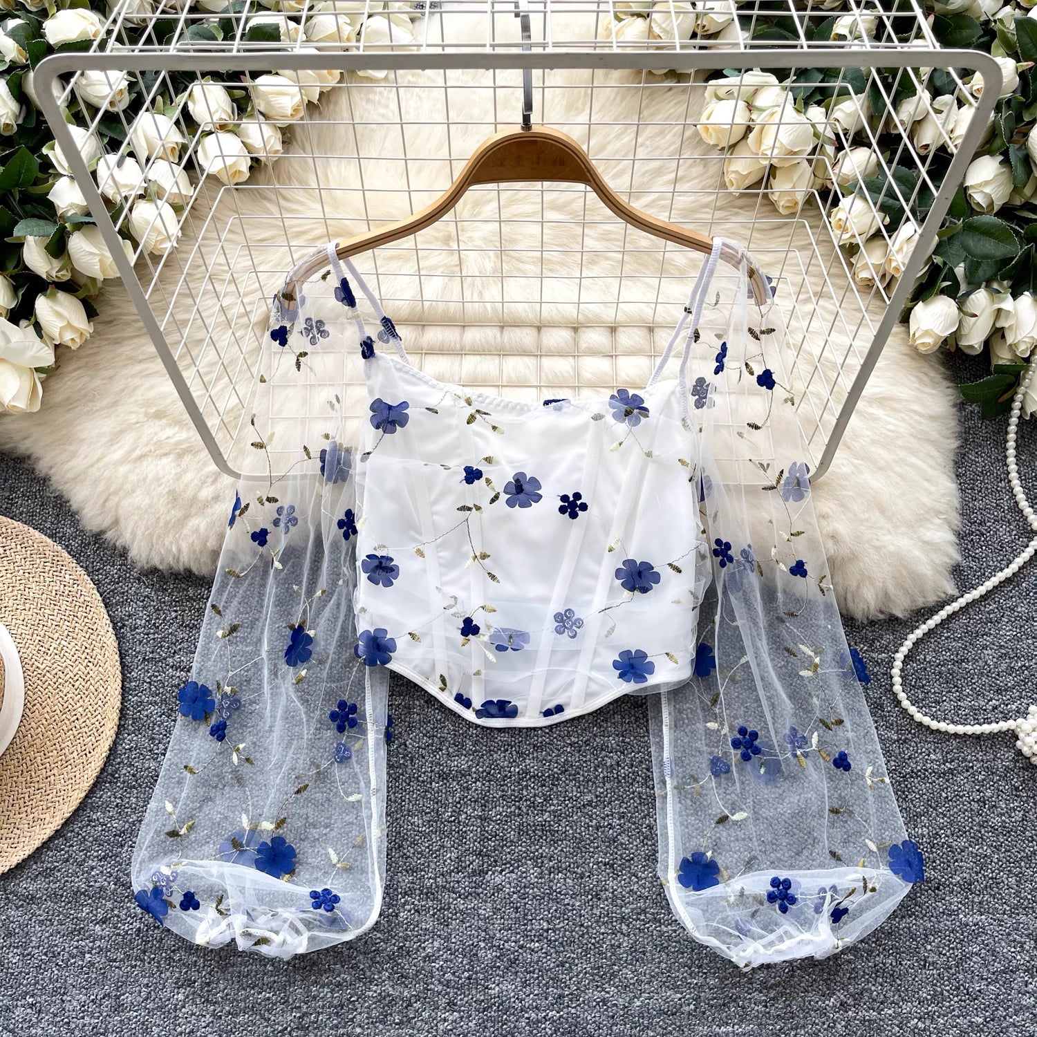 Orchid Moda enchanted sheer floral mesh top with blue flowers and long puff sleeves on hanger