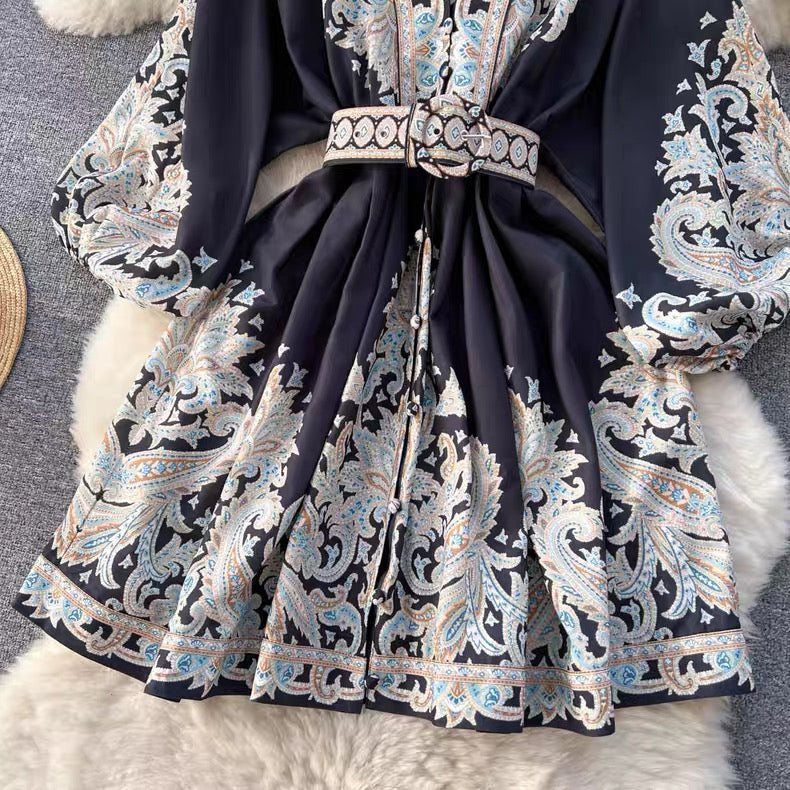 Orchid Moda floral paisley mini dress with long sleeves and matching belt in black and pastel colors