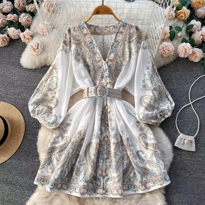 Orchid Moda floral paisley mini dress with long puff sleeves and matching belt on hanger