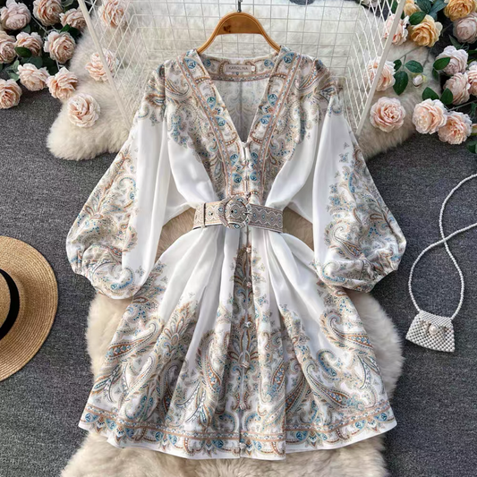 Orchid Moda floral paisley mini dress with long puff sleeves and matching belt on hanger