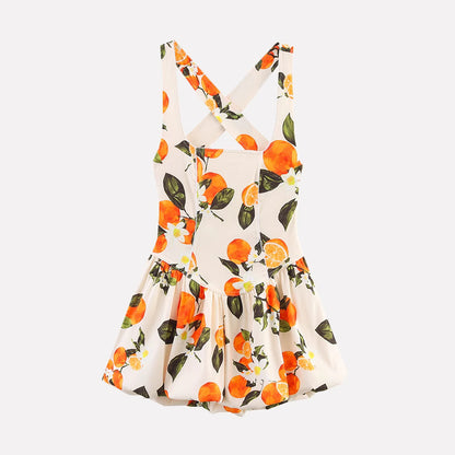 Orchid Moda floral printed sundress with orange fruit design and cross back straps on white background