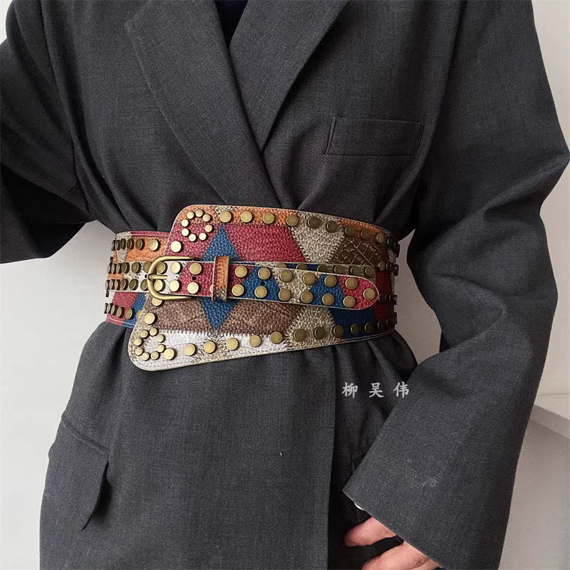 Orchid Moda gypsy buckle wide belt for women in multicolor with stud detailing worn over dark gray blazer