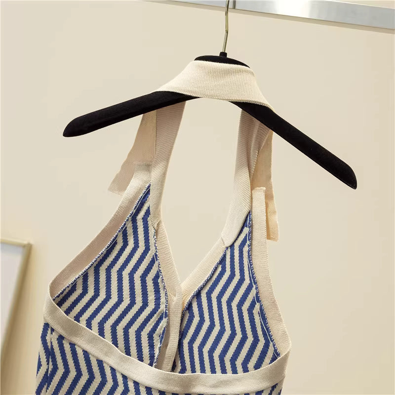 Orchid Moda blue and beige halter neck backless top with geometric pattern hanging on a black and white hanger