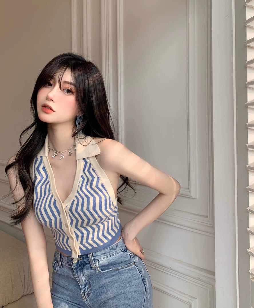 Woman wearing a blue and beige striped halter neck backless top paired with high-waisted jeans