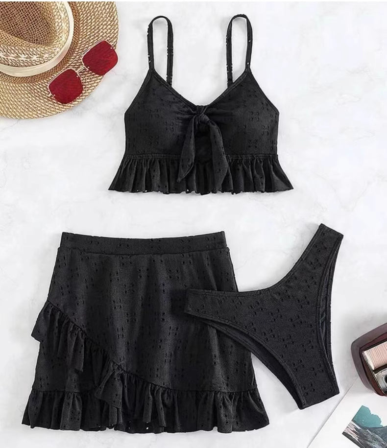 Orchid Moda black knot front swimwear set with ruffled skirt and bikini bottom flat lay