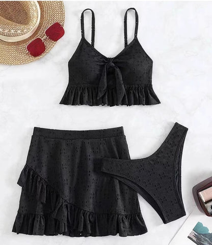 Orchid Moda black knot front swimwear set with ruffled skirt and bikini bottom flat lay