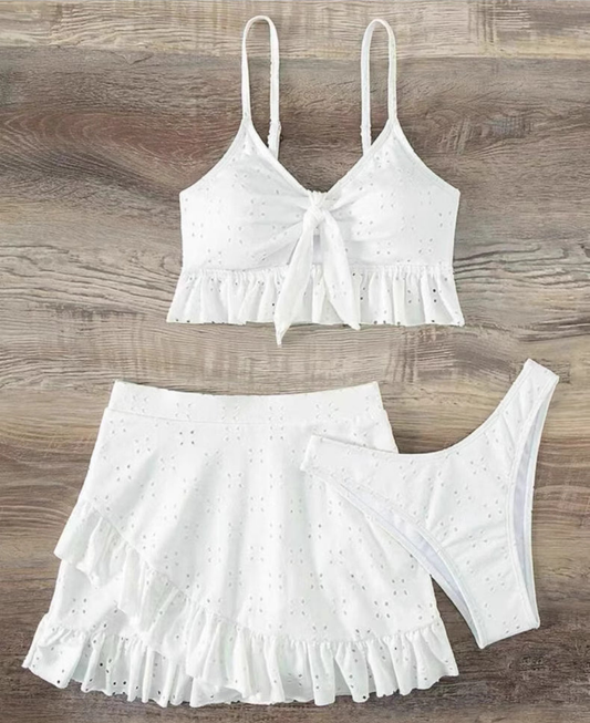 Orchid Moda white knot front swimwear set with ruffled crop top, high-waist bottom, and matching skirt