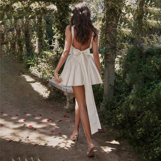 Orchid Moda knotted bow mini dress for women in white with open back and long bow detail