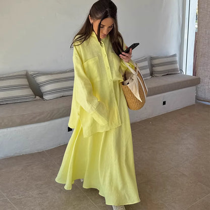 Woman wearing lemon yellow co ord set with oversized shirt and flowing skirt indoors