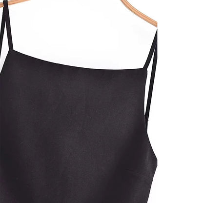 Orchid Moda minimalist women's tank top in black with thin straps hanging on wooden hanger