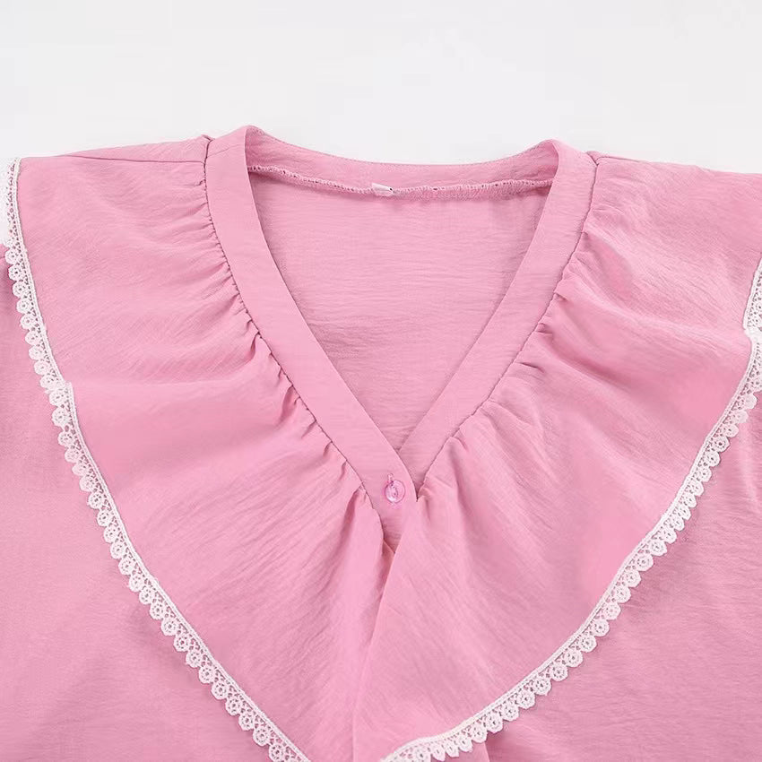 Close-up of pink flare shorts and top set from Orchid Moda featuring lace trim and v-neck design