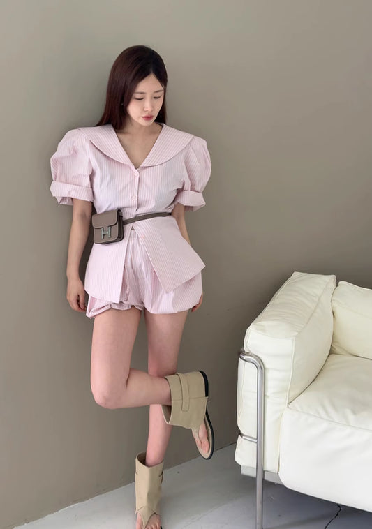 Orchid Moda pink puff sleeve short set with belted waist and relaxed fit styled with beige boots