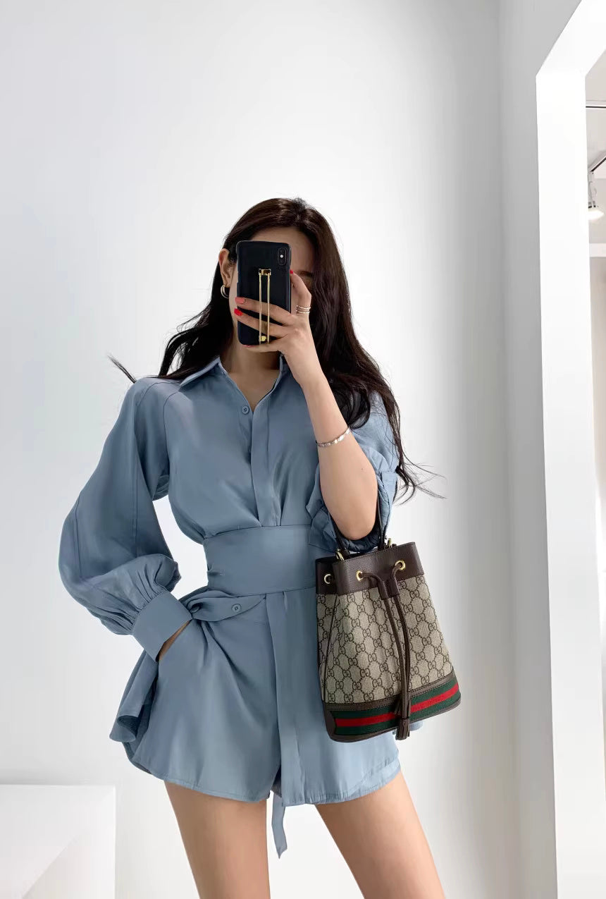 Woman wearing a blue retro co-ord set with long puff sleeves and high-waisted shorts by Orchid Moda