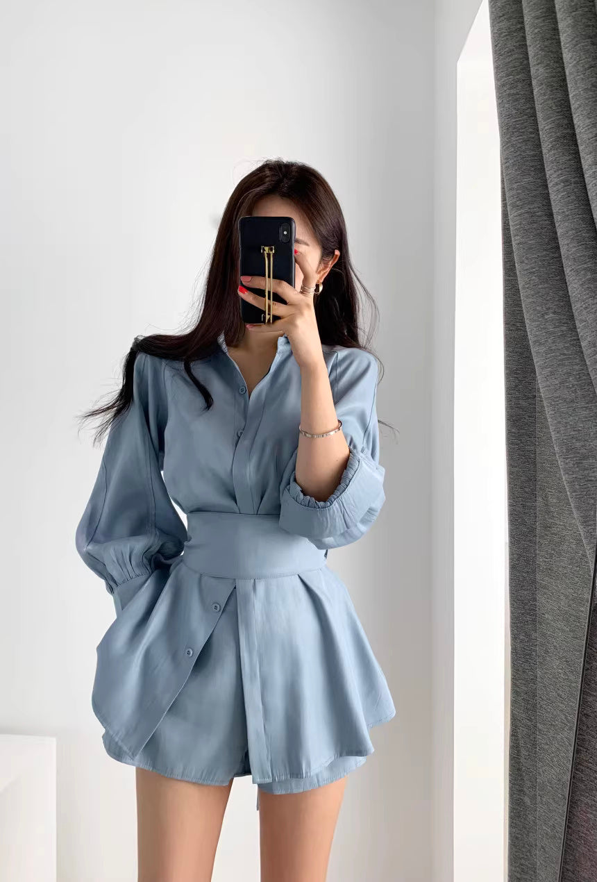 Woman wearing a light blue retro co-ord set with long sleeves and a flared skirt by Orchid Moda