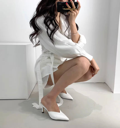 Orchid Moda white retro co-ord set with long sleeves and matching white pointed heels