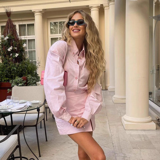Woman wearing Orchid Moda pink striped rosebud co ord set online with long sleeves and mini skirt