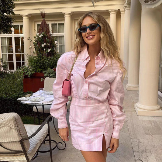 Woman wearing pink striped rosebud co ord set online with long sleeve shirt and mini skirt with slit