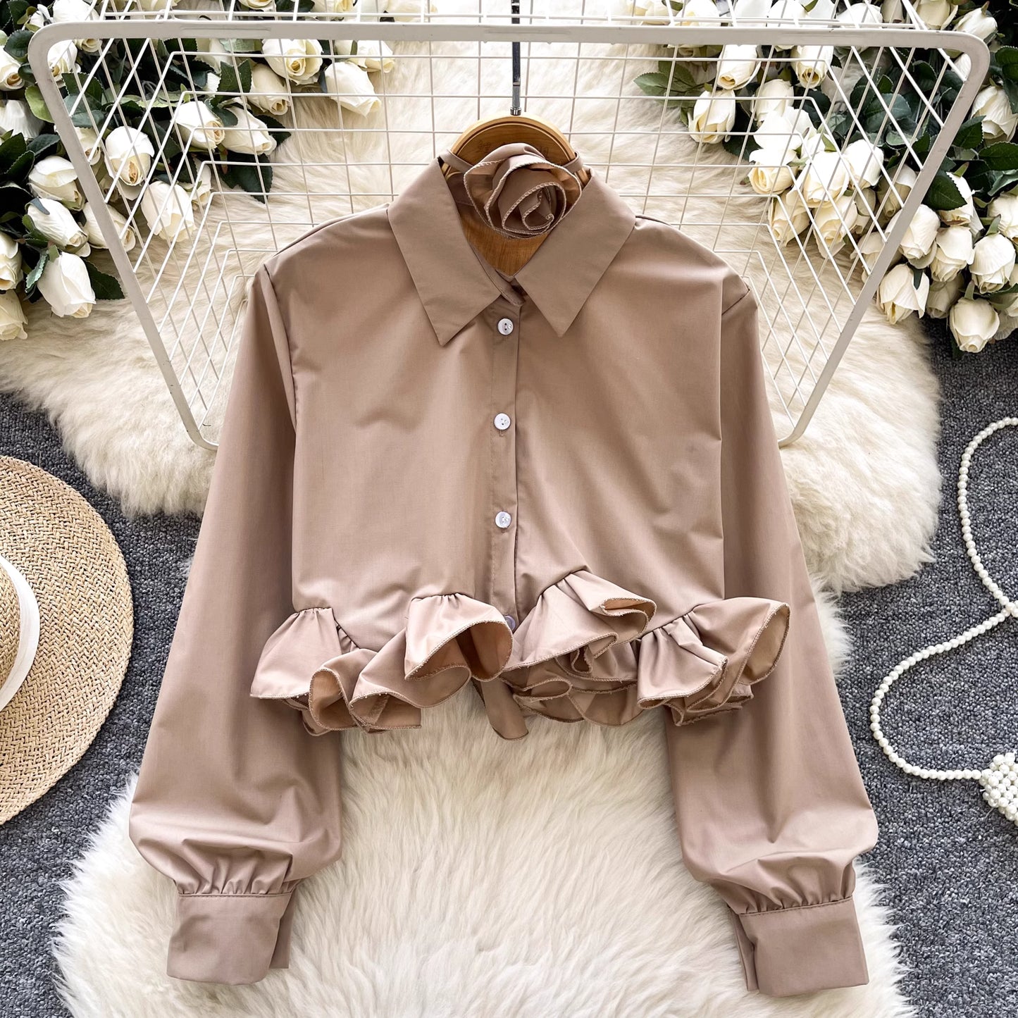 Orchid Moda ruffle rose pink shirt with long sleeves and button front on a hanger