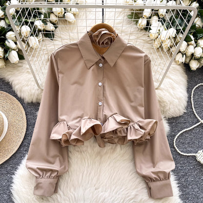 Orchid Moda ruffle rose pink shirt with long sleeves and button front on a hanger