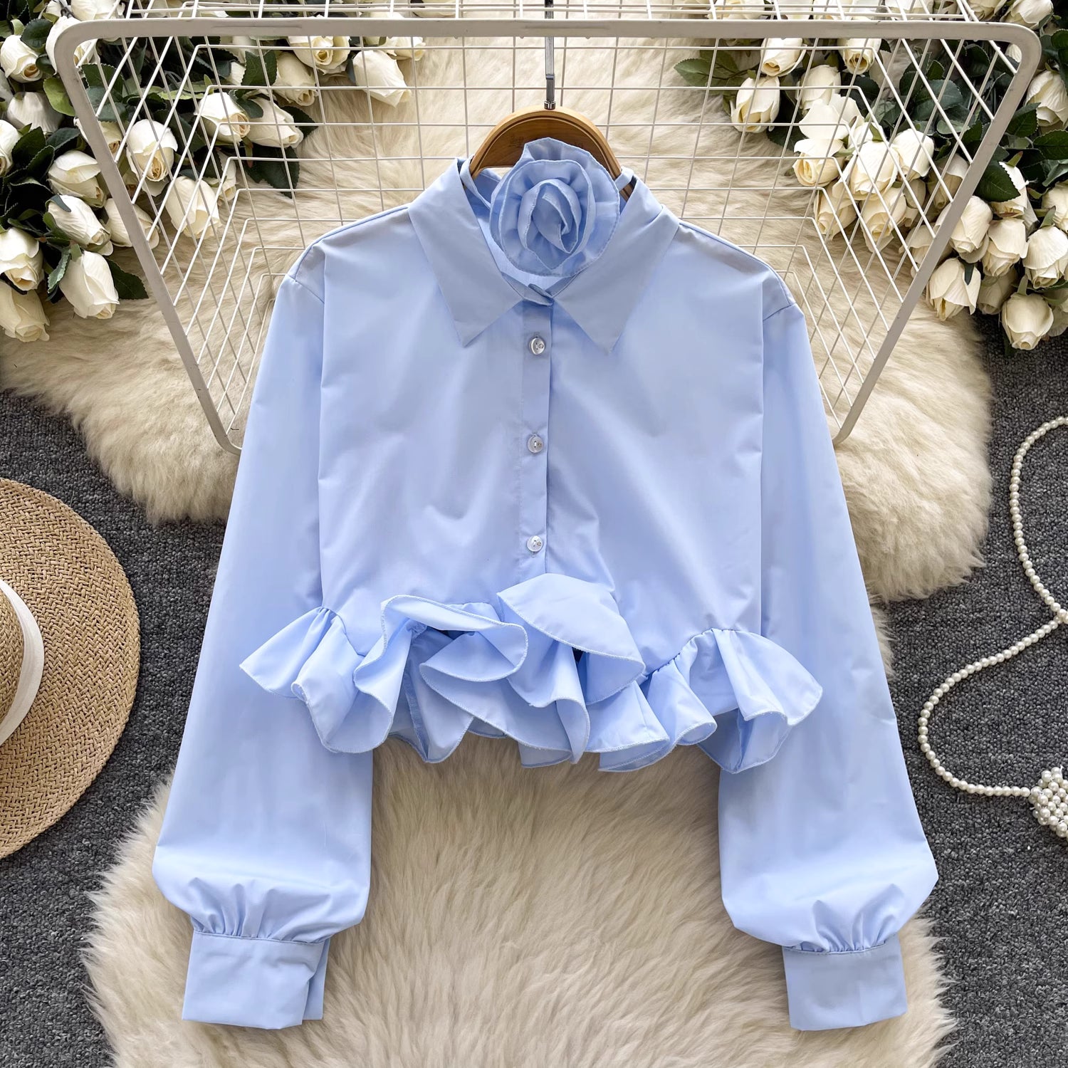 Orchid Moda light blue shirt with ruffle details and a flower accessory, styled as ruffle rose pink shirt