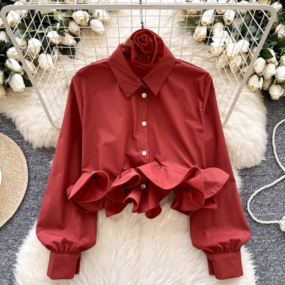 Orchid Moda ruffle rose pink shirt with button-up front and puffed sleeve cuffs on white fur background