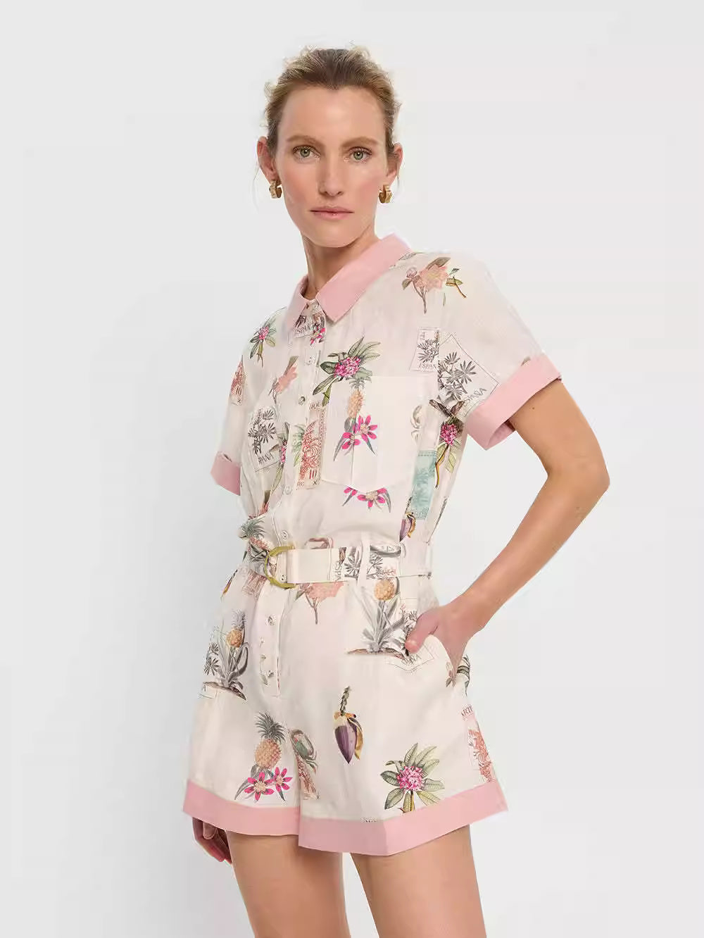 Orchid Moda short sleeve linen romper with floral print and pink trim collar and cuffs