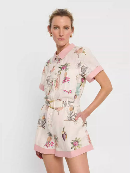 Orchid Moda short sleeve linen romper with floral print and pink trim collar and cuffs