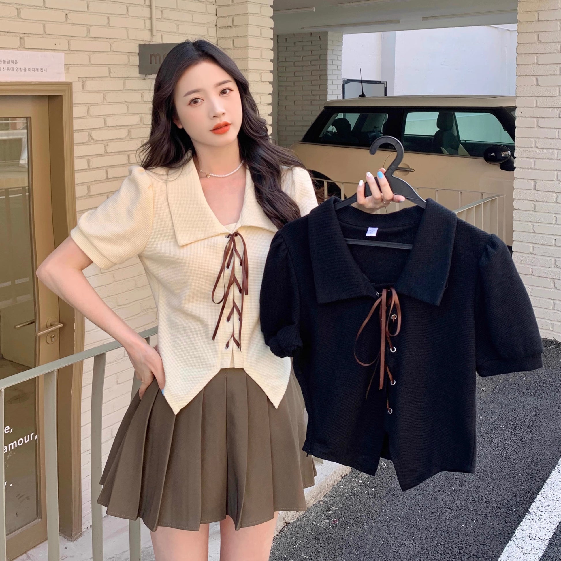Orchid Moda short sleeve statement shirt in cream worn by model holding black version