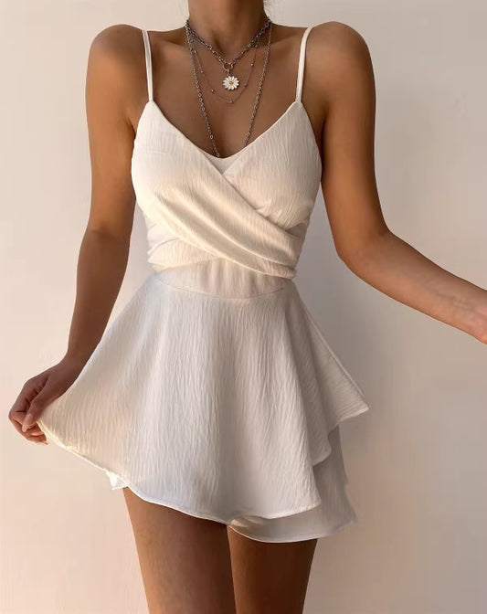 Woman wearing white solid culottes summer outfit with a textured wrap top and layered skirt