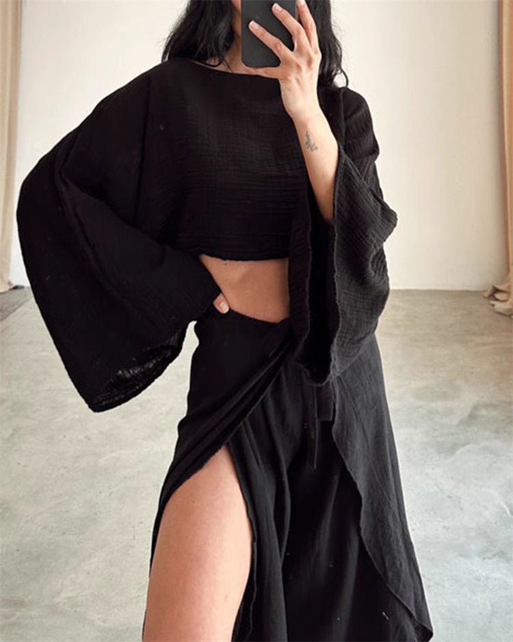 Black split hem pants outfit for women featuring a high slit and wide sleeve crop top