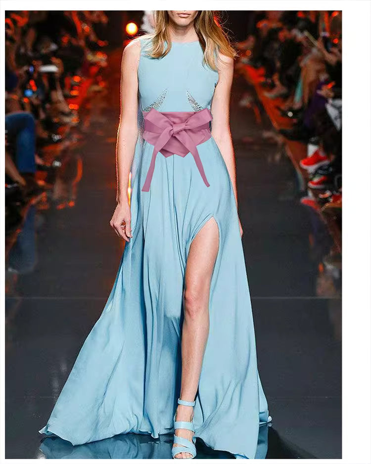 Model wearing a blue gown with a pink stylish waist band for women and high side slit on runway