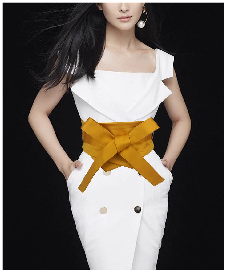 Stylish waist band for women in mustard yellow tied around waist over white dress