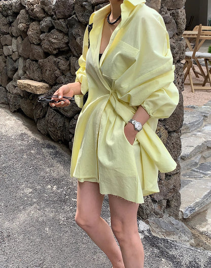 Woman wearing a yellow flowy dress and jacket styled as a sunkissed summer outfit for women by Orchid Moda