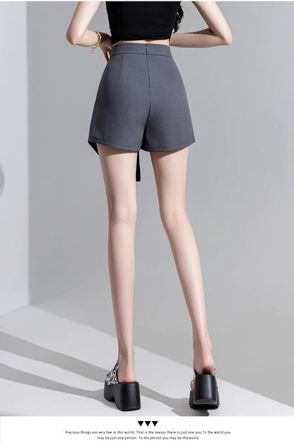 Orchid Moda trendy high waisted skort in dark gray worn with black top and stylish heels