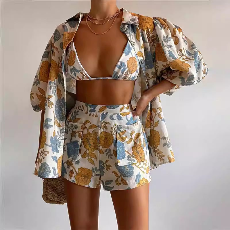Vacation floral print co ords set with puff sleeve shirt, matching shorts, and bikini top in blue and yellow floral design