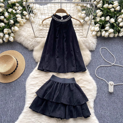 Black beaded co ord set for women with sleeveless top and layered skirt displayed on white fur rug