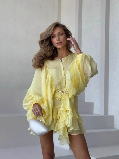 Orchid Moda elegant lantern sleeve dress in yellow with ruffled layers and a waist tie
