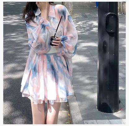 Orchid Moda flowy summer co ord set with pastel tie-dye blouse and matching skirt on woman outdoors