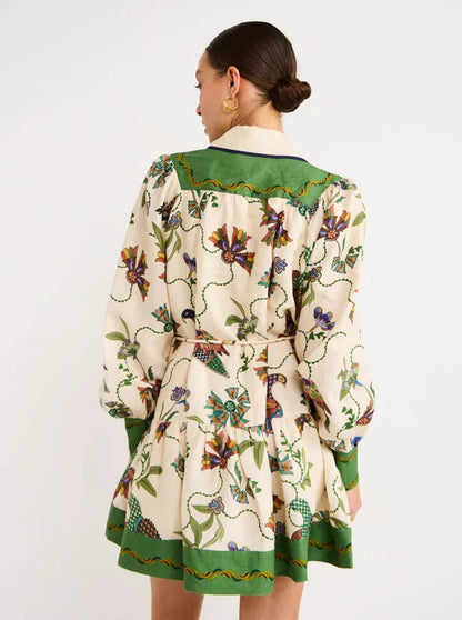 Orchid Moda peacock print lantern sleeve dress with green accents and floral pattern on cream fabric