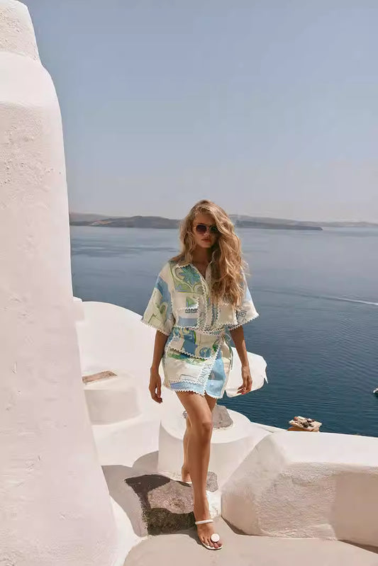 Orchid Moda printed co-ord set for women featuring a stylish short-sleeve top and matching skirt with a coastal backdrop